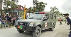  ??  ?? Reporters record as a military ambulance evacuates the dead body of Sergeant Handoko at Moses Kilangin airport in Timika, Papua province, Indonesia.