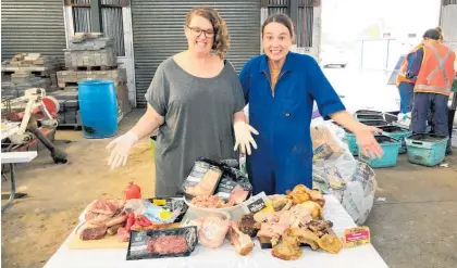  ?? Photo / Waipā District Council ?? Council's waste minimisati­on adviser Sally Fraser (left) and Bethany Rolston with some of the meat — much unopened — thrown out as refuse. Reducing food waste will be one initiative under the spotlight this year.