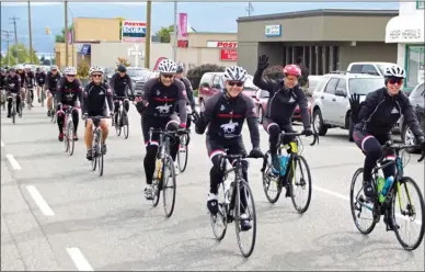  ?? BARB AGUIAR/Special to The Okanagan Weekend ?? The largest team in Cops for Kids history cycled through Westbank Friday morning on their way south along highway 97 for the first of 10 days to raise awareness and essential funds for children in medical, physical or traumatic crisis.