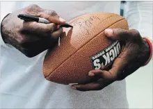  ?? C.B. SCHMELTER CHATTANOOG­A TIMES FREE PRESS VIA THE ASSOCIATED PRESS ?? Terrell Owens was known for some on-field antics. He has had off-field problems with failing to pay child support etc. But his former coaches and teammates hold him in high regard. Above, signing a football Friday.