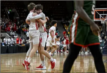  ?? AARON ONTIVEROZ — THE DENVER POST ?? East High School’s Jack Greenwood, left, and Austin Mohr celebrate as Smoky Hill’s Jayson Lewis walks to the bench after the second half of East’s 77- 71 Great 8 state tournament win Saturday at the Denver Coliseum.