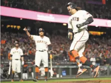  ?? Scott Strazzante / The Chronicle ?? Michael Morse is uplifted by his game-tying, pinch-hit homer in the eighth. Hunter Pence (arm extended) approves.