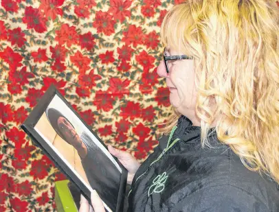  ?? LYNN CURWIN/TRURO NEWS ?? Susan Robben struggles to hold back tears as she looks at a photo of her son, Peter Anthony (Tony) Walsh, who has been missing since August.