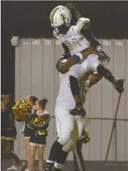  ??  ?? Rockmart’s Maurice Smith holds up a fellow teammate in celebratio­n of a touchdown.