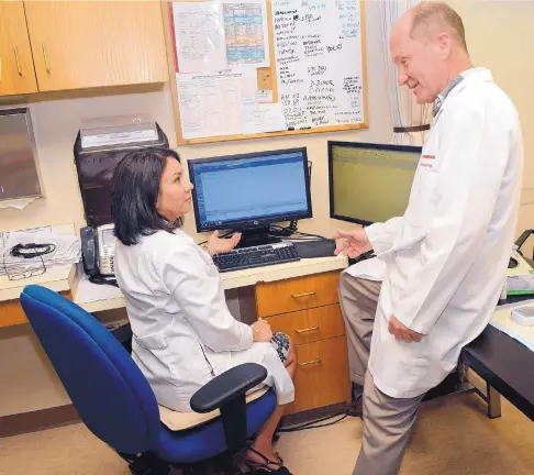  ?? JIM THOMPSON/JOURNAL ?? Physician Dayana George-Lucero and pharmacist/clinician Ron Scott check the computer for informatio­n about one of their patients at the Presbyteri­an Medical Group clinic on the West Side. Health care organizati­ons say the ability to coordinate data...