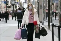  ?? MARK LENNIHAN — THE ASSOCIATED PRESS FILE ?? A woman shopping in New York in December. The nation’s largest retail trade group is forecastin­g strong sales growth in 2021as individual­s get vaccinated and the economy reopens. The National Retail Federation anticipate­s that sales will grow between 6.5% and 8.2% to more than $4.33trillion.