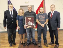  ?? Petty Officer 1st Class Pedro Ro ?? From left, Michael Desch, Patricia Hughes Prickett, Carl Hughes, Larry Hughes Jr. and Jim Webb, former senator from Virginia, with the framed shadow box containing the dog tag that belonged to Cpl. Larry Hughes, a Vietnam veteran who died in 2019. Cpl. Hughes’ family was presented with the recently found dog tag on Feb. 17.