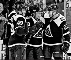  ??  ?? Colorado Avalanche right wing Sven Andrighett­o (10), center Colin Wilson (22) and Samuel Girard celebrate a goal against the Blackhawks during the third period Saturday.