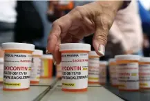  ?? Associated Press ?? ■ Family and friends who have lost loved ones to OxyContin and opioid overdoses leave pill bottles in protest Aug. 17, 2018, outside the headquarte­rs of Purdue Pharma, which is owned by the Sackler family, in Stamford, Conn. New York is suing the billionair­e family behind Oxycontin, alleging the drugmaker fueled the opioid crisis by putting hunger for profits over patient safety.