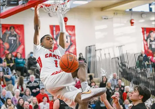  ?? Photos by Jim Franco / Times Union ?? Albany Academy senior Bobby Chandler dunks in front of Rice Memorial senior Carter Blanchard on Saturday at Albany Academy in Albany. Chandler had a team-high 28 points in the victory on Senior Day.