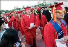  ??  ?? Porteville College’s graduating students walk down the track Friday, May 11, at the 90th Commenceme­nt ceremony at Jamison Stadium in Portervill­e.