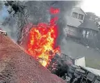  ??  ?? FIERY END: The truck on fire down the embankment