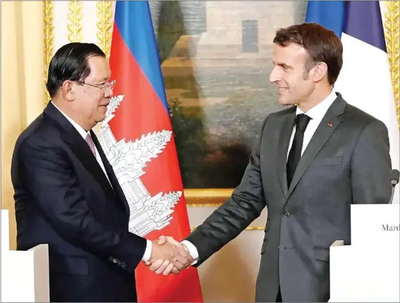  ?? AFP ?? Prime Minister Hun Sen (left), who is also this year’s ASEAN chair, greets French President Emmanuel Macron prior to a working dinner at the presidenti­al Elysee Palace, in Paris, on December 13.