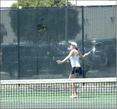  ?? Photos by ALEX FARRER / For the Calhoun Times ?? ( Calhoun’s Emma King waits to hit a return during her No. 3 singles match on Wednesday. ( Calhoun’s McCartney Kessler loads up for a backhand in her No. 1 singles match.