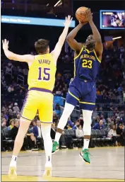  ?? LACHLAN CUNNINGHAM — GETTY IMAGES ?? Draymond Green (23) of the Golden State Warriors shoots over Austin Reaves (15) of the Los Angeles Lakers in the second half at Chase Center on Thursday in San Francisco.