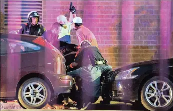  ??  ?? POLICE PROTECTION: Dallas police shield bystanders after shots were fired on Thursday during a protest over two recent fatal police shootings of black men.