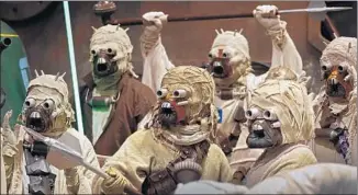  ??  ?? FANS DRESSED as Tusken Raiders, a nomadic, primitive group often hostile to settlers, pose for a photo during the Star Wars Celebratio­n. “Episode VII: The Force Awakens” is due in December.