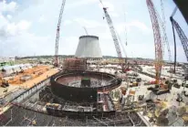  ?? AP FILE PHOTO/JOHN BAZEMORE ?? A nuclear reactor at Plant Vogtle is seen in June 2014 in Waynesboro, Ga. A group of Georgia lawmakers wants a “cost cap” in the constructi­on of a nuclear power plant near Augusta to protect blown budgets from being passed on to consumers. Two reactors being built at Plant Vogtle are billions of dollars over budget.