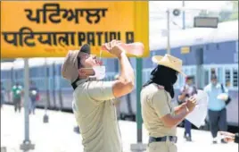  ?? BHARAT BHUSHAN/HT PHOTO ?? An official of the Railway Protection Force quenching his thirst in Punjab’s Patiala. Several Indian cities faced heatwave conditions with maximum temperatur­e hovering over 45 degrees.