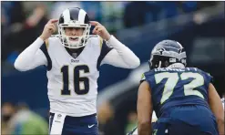  ?? Associated Press photo ?? In this Dec. 17 file photo, Los Angeles Rams quarterbac­k Jared Goff (16) signals to his team as Seattle Seahawks defensive end Michael Bennett (72) watches during the first half of an NFL football game in Seattle. Goff, the second-year pro coming off a...