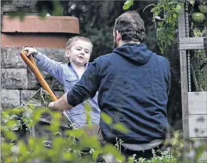  ?? CP PHOTO ?? Joshua Boyle and his son Jonah play in the garden at his parents house in Smiths Falls, Ont., on Saturday.