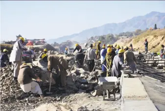  ?? Aqeel Ahmed / Associated Press 2017 ?? Workers in Haripur, Pakistan, toil on a China-financed highway project — part of a modern Silk Road of railways, ports and other facilities linking Asia with Europe.