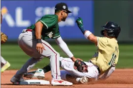  ?? CAEAN COUTO — THE ASSOCIATED PRESS ?? Boston Red Sox prospect Marcelo Mayer slides into second base as he beats the throw to Arizona Diamondbac­ks prospect Jordan Lawlar during the first inning of the MLB All-star Futures game on July 8, 2023in Seattle.