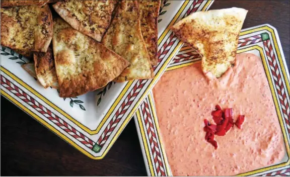  ?? PHOTO BY EMILY RYAN ?? WINERY Impress guests with homemade tortilla chips and this creamy dip featuring roasted red peppers.