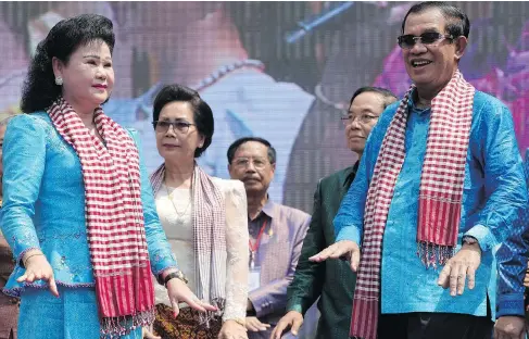  ?? TANG CHHIN SOTHY / AFP / GETTY IMAGES ?? Cambodian Prime Minister Hun Sen, right, and his wife Bun Rany at a New Year’s ceremony last year. Hun Sen’s efforts to stifle opposition have intensifie­d recently, much of it containing a strong anti-American streak, as he seeks to extend his 33-year...
