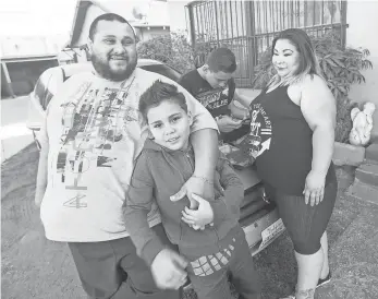  ?? OMAR ORNELAS, USA TODAY NETWORK ?? Rene Flores and his wife, Marlenis, outside his home with their children, Napoleon, 11, and Jose, 13.