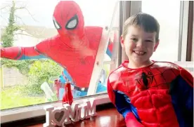  ?? ?? Above: Spider-man drops in to clean the windows in Spencers Wood
Below left: Council leader John Halsall gets his covid jab
Below right: Shelagh Casebourne with her painting for the Sky Arts contest