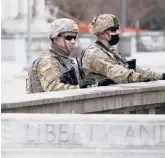  ?? JACQUELINE LARMA/AP ?? National Guard members are posted Sunday near the front of the main entrance to the state Capitol in Harrisburg, Pennsylvan­ia.