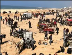  ?? MAHMOUD ESSA — THE ASSOCIATED PRESS ?? Palestinia­ns wait for humanitari­an aid on a beachfront in Gaza City, Gaza Strip, Feb. 25.