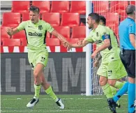  ??  ?? Marcos Llorente (left) celebrates after scoring Atletico Madrid’s first goal against Granada