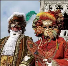  ?? Rick Steves’ Europe/SIMON GRIFFITH ?? Revelers in ornate, outrageous costumes and colorful masks descend upon Venice during Carnival.