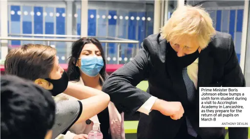  ?? ANTHONY DEVLIN ?? Prime Minister Boris Johnson elbow bumps a sixth form student during a visit to Accrington Academy in Lancashire, as they prepare for the return of all pupils on March 8