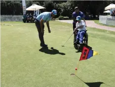  ??  ?? COACH Carlo Kok from Southern Cape Golf Union puts Charlie De Souza through his paces in the 2018 SA Disabled Golf Associatio­n’s First Swing inter-schools golf tournament in the Western Cape. Young golfers put their chipping and swinging skills to the test.