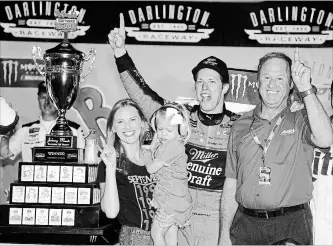  ?? TERRY RENNA
THE ASSOCIATED PRESS ?? Brad Keselowski celebrates with his wife, Paige, daughter, Scarlett, and former Team Penske driver Rusty Wallace, right, in Victory Lane after winning the NASCAR Cup Series auto race in Darlington, S.C., on Sunday.