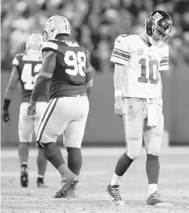  ?? MATT LUDTKE/ASSOCIATED PRESS ?? The Giants’ Eli Manning walks off the field after an incomplete pass against the Packers. “Guys are committed to doing whatever it takes to change things and get back to winning again,” Manning said of today’s game against the Ravens.