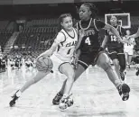  ?? ?? Clark’s Natalie Huff (1) tries to drive on DeSoto’s Ja’Mia Smith. The Cougars stayed with the nation’s No. 2 team for three quarters.