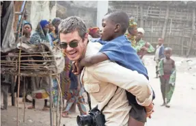  ?? CHARITY:WATER ?? Scott Harrison, founder and CEO of charity: water, hangs out with kids in Liberia. Harrison’s new book, “Thirst,” is on sale now.