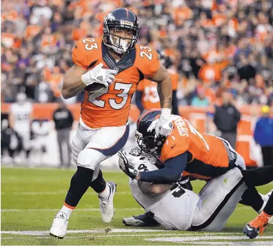 ?? JACK DEMPSEY/ASSOCIATED PRESS ?? Denver Broncos running back Devontae Booker (23) runs for a touchdown during the first half of Sunday’s game. Booker also had a receiving touchdown in the contest as Denver snapped a three-game losing streak.