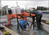  ??  ?? Installing the cart and churns at the now revamped fountain.