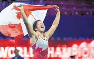  ?? BALAZS CZAGANY THE ASSOCIATED PRESS ?? Canadian wrestler Justina Di Stasio is all smiles after winning gold at the worlds in Budapest.