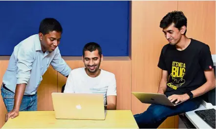  ?? — AFP ?? Misunderst­ood lot: (From left) Ethical hackers Rohit Raj, Prakash and Shashank of Appsecure India at work in Bangalore.