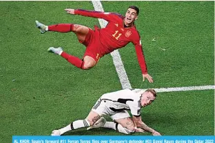  ?? ?? AL KHOR: Spain’s forward #11 Ferran Torres flies over Germany’s defender #03 David Raum during the Qatar 2022 World Cup Group E football match between Spain and Germany on November 27, 2022. —AFP