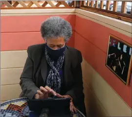  ?? Associated Press photo ?? Lynnette White uses her tablet in San Francisco. The pandemic has sparked a surge of online shopping across all ages as people stay away from physical stores. But the biggest growth has come from consumers 65 and older.
