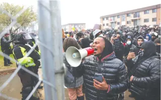  ?? (Leah Millis/Reuters) ?? PROTESTERS RALLY outside a heavily guarded Brooklyn Center, Minnesota police station, Monday, a day after Daunte Wright was shot and killed by a police officer.