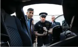  ?? ?? Rishi Sunak (left) being shown a new electric hybrid police car during a media visit to Harlow, 16 February 2024. Photograph: Dan Kitwood/AFP/Getty Images