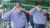  ?? ?? World War II veteran Doyle Branscum and his son, Vietnam veteran Win Branscum, stand and salute during the Posting of Colors.
